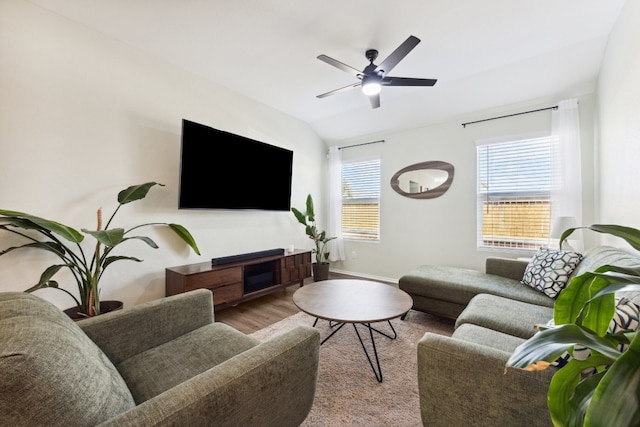 living room featuring vaulted ceiling, light hardwood / wood-style floors, and ceiling fan