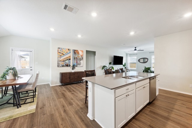 kitchen with an island with sink, white cabinetry, wood-type flooring, dishwasher, and sink