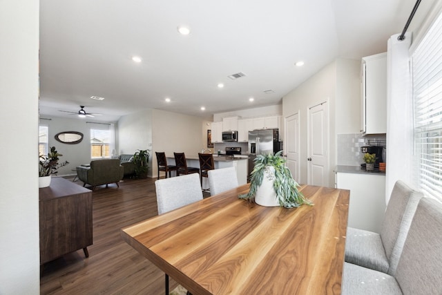 dining room with dark wood-type flooring and ceiling fan