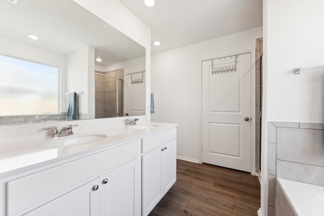 bathroom featuring vanity, hardwood / wood-style flooring, and shower with separate bathtub