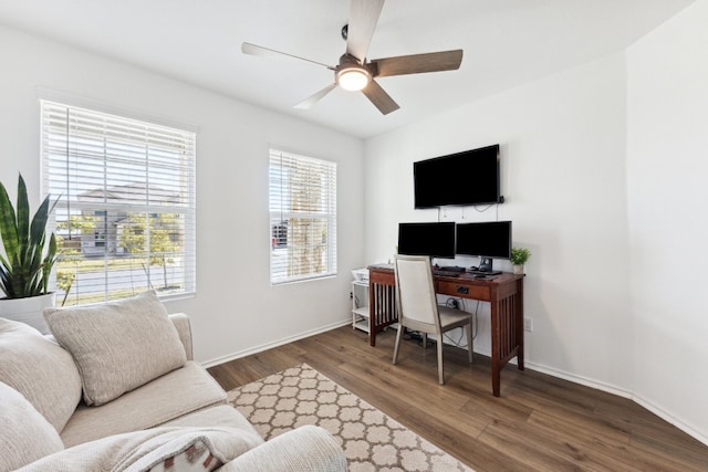 office area with dark wood-type flooring and ceiling fan