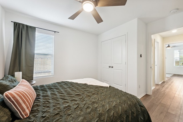 bedroom featuring a closet, ceiling fan, and wood-type flooring