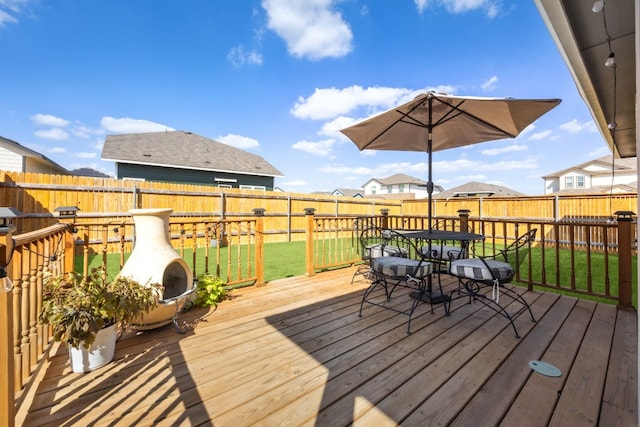 wooden terrace featuring a lawn