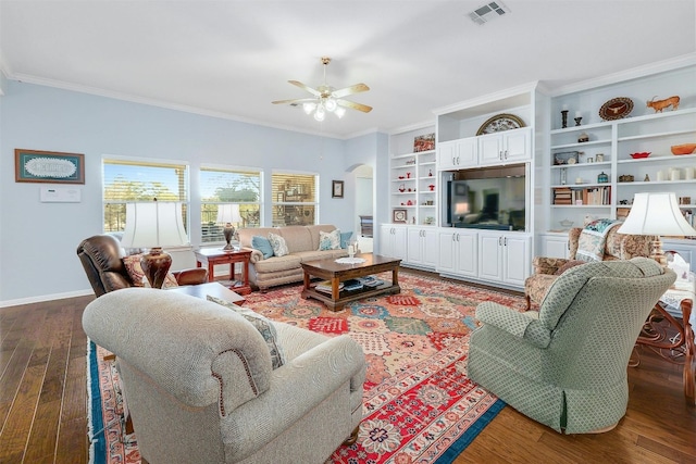 living room with ornamental molding, wood-type flooring, and ceiling fan