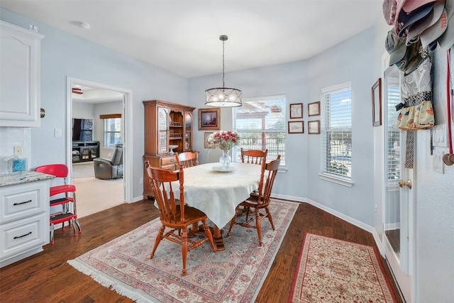 dining room featuring a chandelier, plenty of natural light, and dark hardwood / wood-style flooring