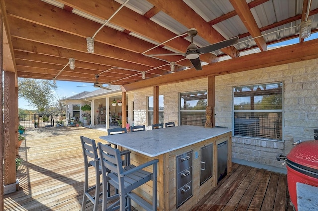 wooden terrace featuring ceiling fan