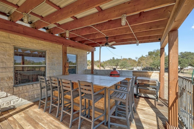 deck with ceiling fan and exterior bar