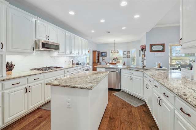 kitchen with appliances with stainless steel finishes, white cabinets, and sink