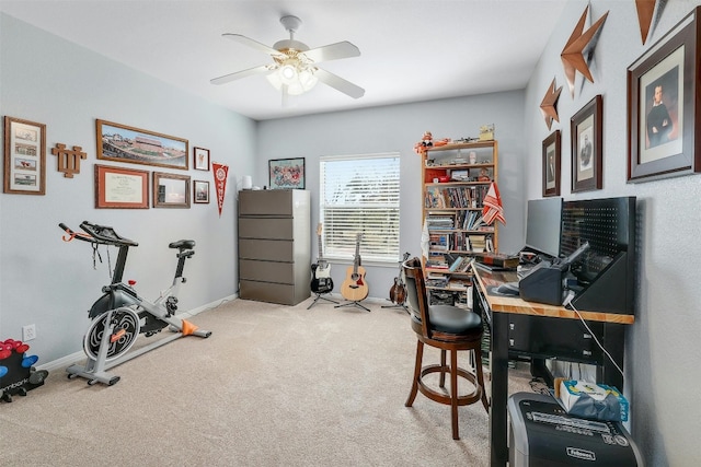 home office featuring light carpet and ceiling fan