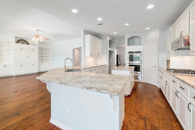1900 County Road 245, Georgetown, TX 78633 - kitchen featuring appliances with stainless steel finishes, a warming drawer, a kitchen island, a peninsula, and backsplash