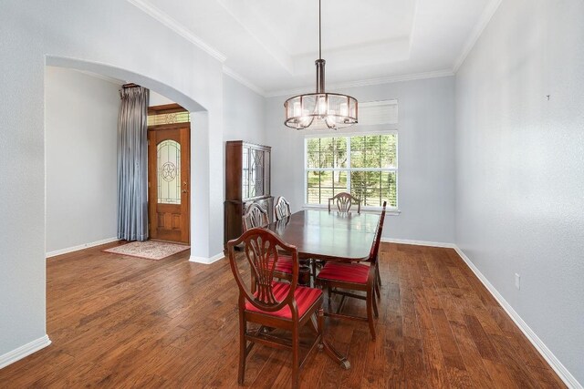 1900 County Road 245, Georgetown, TX 78633 - dining space with a raised ceiling, arched walkways, dark wood-style floors, a chandelier, and crown molding