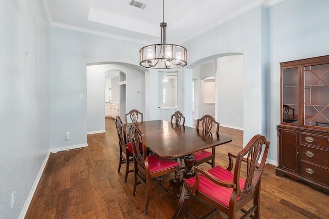1900 County Road 245, Georgetown, TX 78633 - dining space featuring arched walkways, dark wood-style flooring, a chandelier, crown molding, and a raised ceiling
