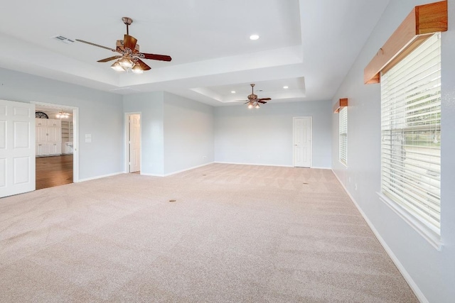 1900 County Road 245, Georgetown, TX 78633 - empty room with a tray ceiling, ceiling fan, light colored carpet, and recessed lighting