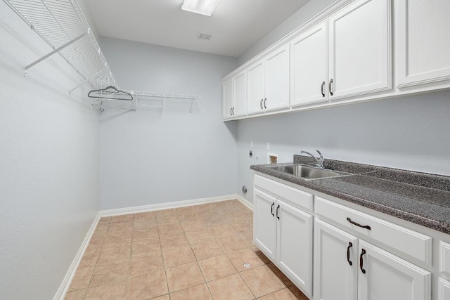 1900 County Road 245, Georgetown, TX 78633 - laundry room featuring electric dryer hookup, washer hookup, cabinet space, and light tile patterned flooring