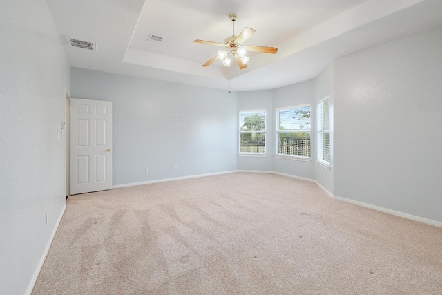 1900 County Road 245, Georgetown, TX 78633 - carpeted spare room featuring a tray ceiling and a ceiling fan