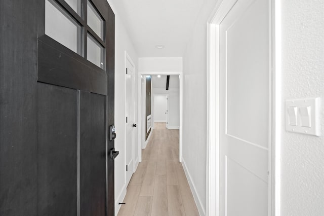 hall with light hardwood / wood-style flooring