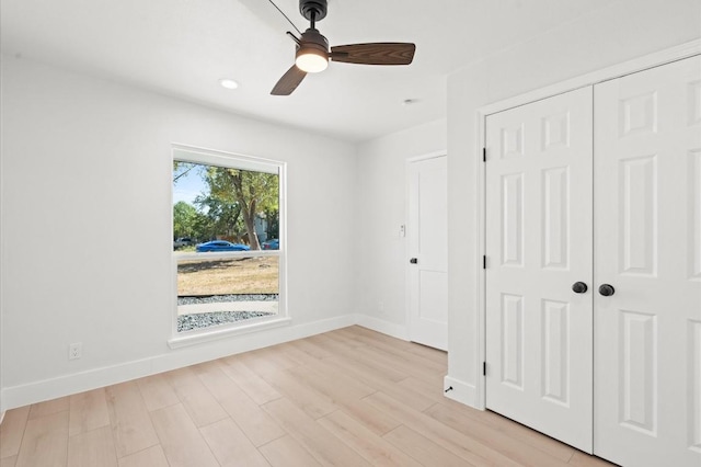 spare room featuring ceiling fan and light hardwood / wood-style flooring