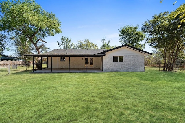 rear view of property with a patio area and a yard