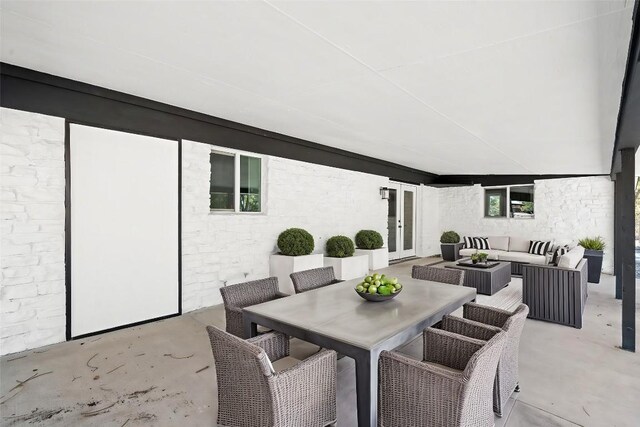 view of patio with an outdoor living space and french doors