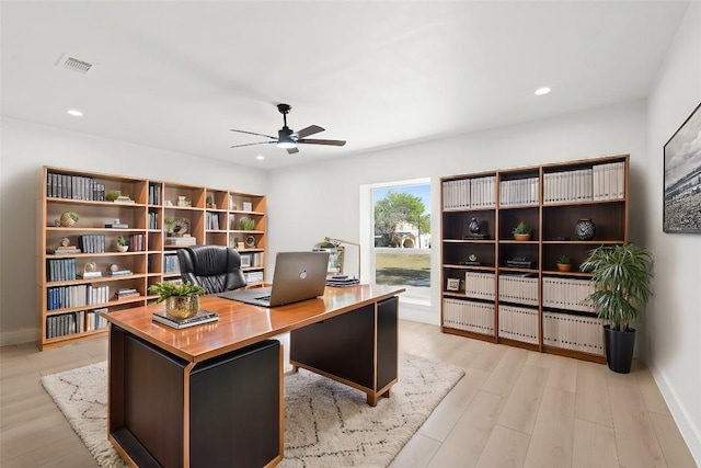 office with ceiling fan and light hardwood / wood-style flooring