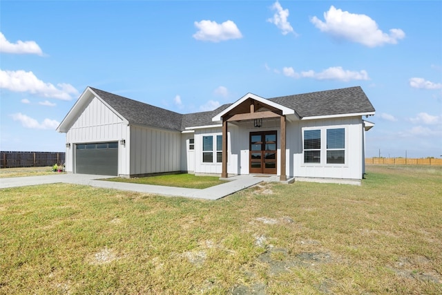 view of front of house featuring a garage and a front lawn