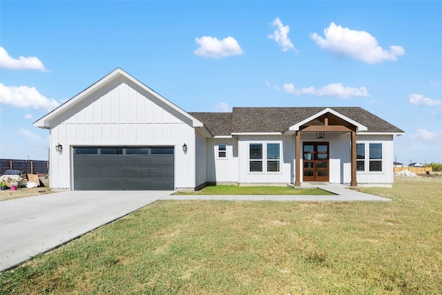 modern farmhouse style home with french doors, a front lawn, and a garage