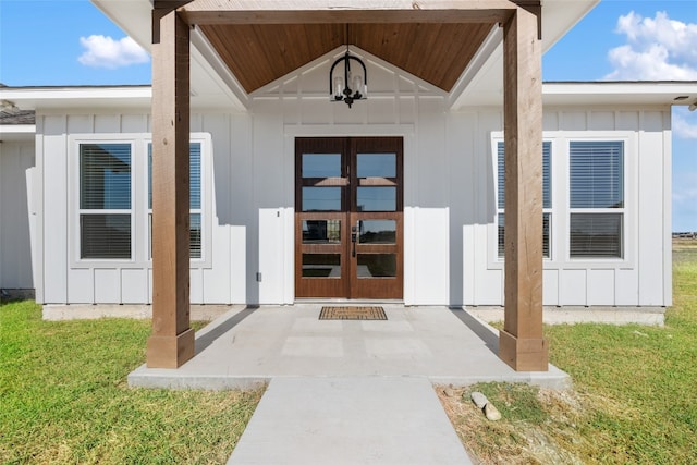 doorway to property with french doors and a yard