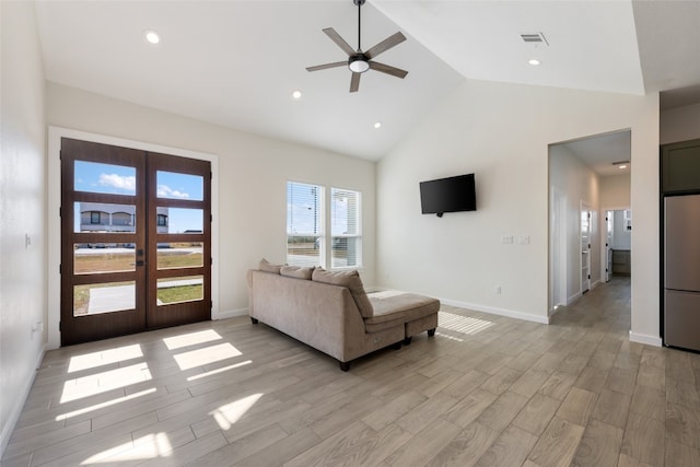 living room featuring light hardwood / wood-style flooring, french doors, high vaulted ceiling, and ceiling fan