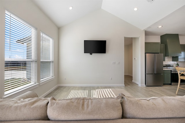 living room with light hardwood / wood-style flooring and lofted ceiling