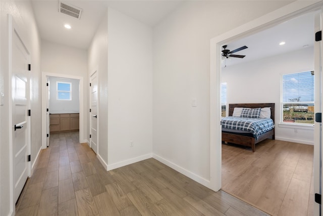 hallway with light hardwood / wood-style floors