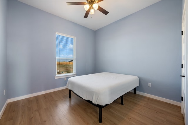 bedroom with light hardwood / wood-style flooring and ceiling fan