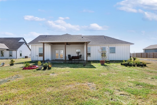 back of house with a patio area and a lawn