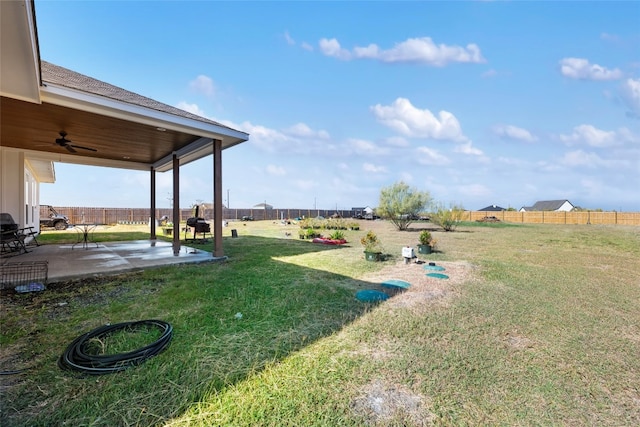 view of yard with a patio area and ceiling fan