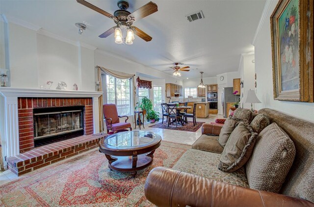11205 Appletree Ln, Austin, TX 78726 - living room featuring ornamental molding, a ceiling fan, a brick fireplace, and light tile patterned floors