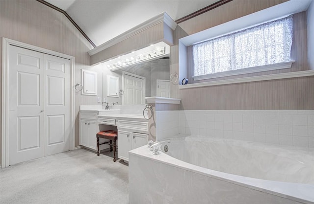 full bath with a bath, vaulted ceiling, and vanity