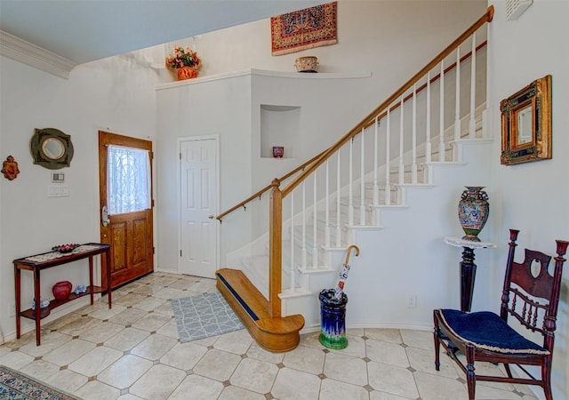 entrance foyer featuring baseboards and stairs