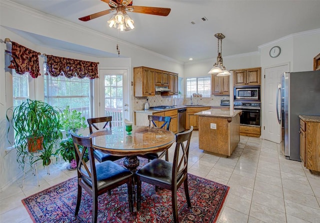 dining room with ornamental molding, light tile patterned flooring, a ceiling fan, and visible vents