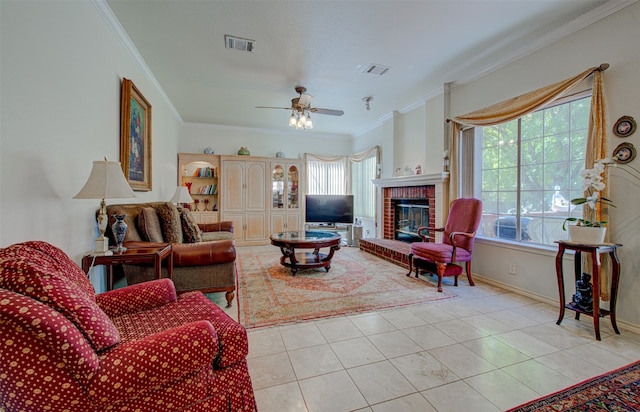 tiled living room with crown molding, plenty of natural light, a fireplace, and ceiling fan