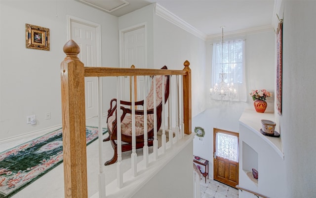 stairway featuring crown molding and a notable chandelier