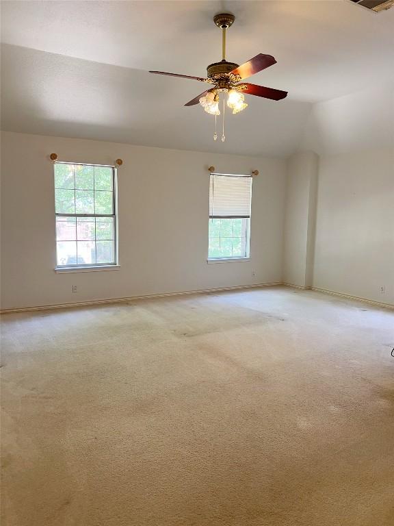 11205 Appletree Ln, Austin, TX 78726 - unfurnished room featuring light carpet, baseboards, ceiling fan, and lofted ceiling
