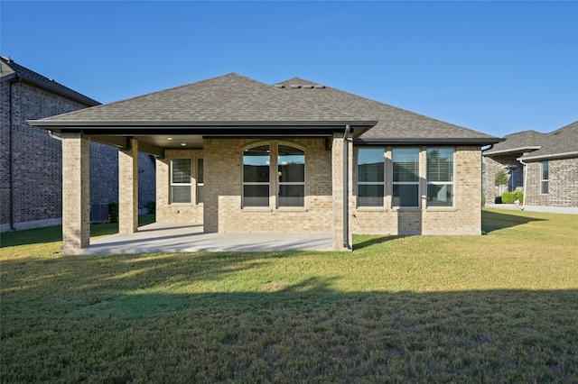 rear view of property with a patio area, central AC, and a lawn