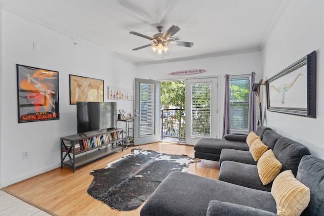 living room with ceiling fan, ornamental molding, and light hardwood / wood-style flooring