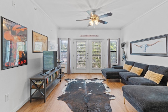 living room featuring light hardwood / wood-style flooring, french doors, ceiling fan, and crown molding