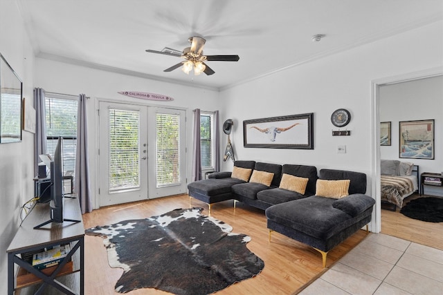 living room featuring light hardwood / wood-style floors, crown molding, french doors, and ceiling fan