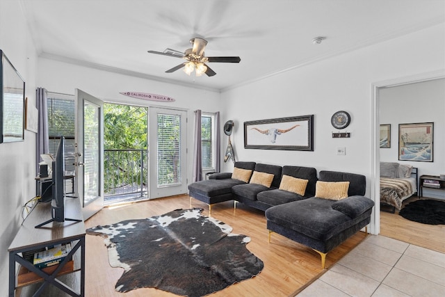 living room with ornamental molding, light hardwood / wood-style floors, and ceiling fan