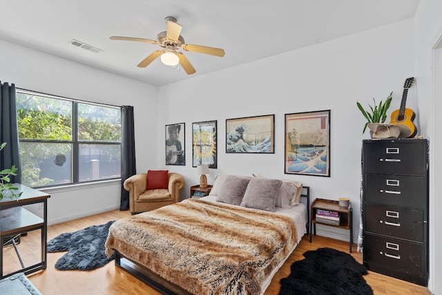 bedroom with ceiling fan and light hardwood / wood-style flooring