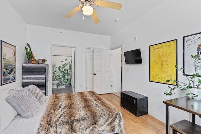 bedroom with ensuite bath, hardwood / wood-style flooring, and ceiling fan