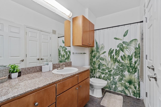 full bathroom featuring vanity, toilet, tile patterned flooring, and shower / tub combo with curtain