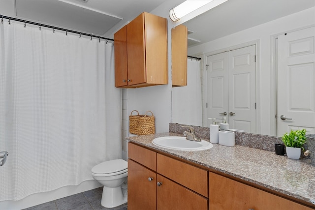 bathroom featuring vanity, toilet, and tile patterned floors