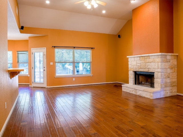 unfurnished living room with ceiling fan, wood-type flooring, lofted ceiling, and a fireplace